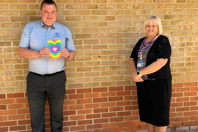 Andy Baker from CJS Portsmouth recieving a badge from Hazel Read, facilities management support services manager for Solent NHS Trust