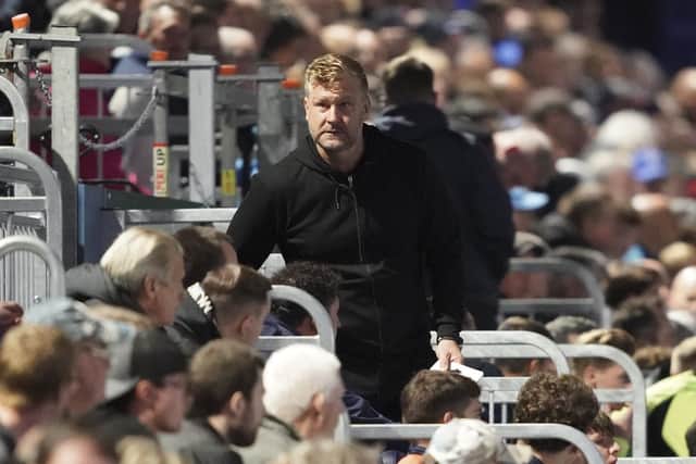 Oxford United manager Karl Robinson takes his place in the dugouts at Fratton Park