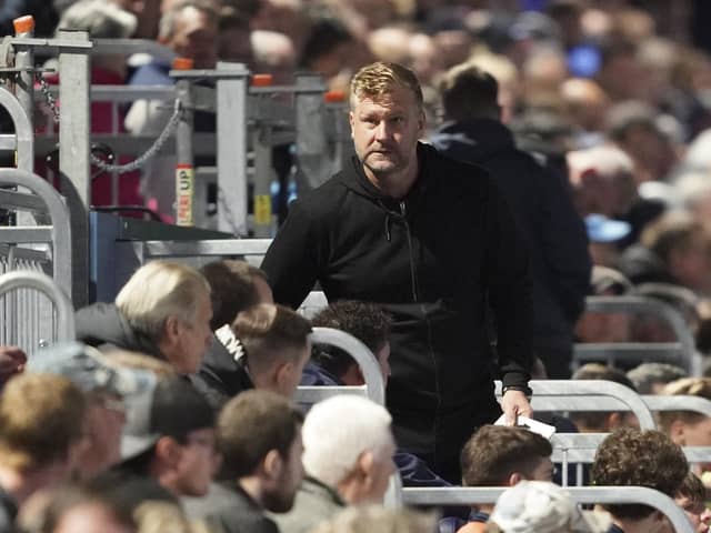 Oxford United manager Karl Robinson takes his place in the dugouts at Fratton Park