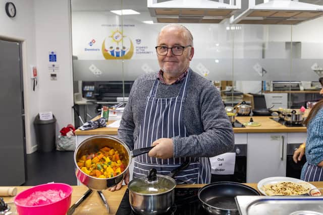 Ian Grant prepared vegetable bhaji for guests at the Winter Warmer event held at the Pompey In The Community centre. Picture: Mike Cooter (101222)