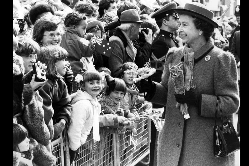Children press forward to greet the Queen on her walkabout in Portsmouth, 1986. The News PP5122