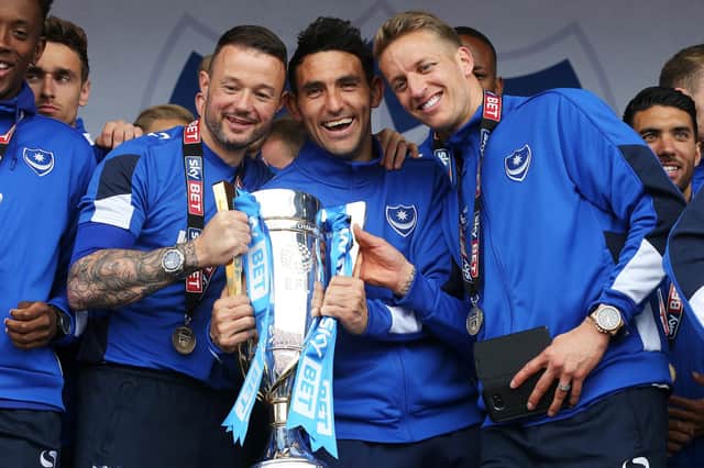 Gary Roberts (centre) is flanked by Noel Hunt and Carl Baker during Southsea Common celebrations after winning the League Two title in May 2017. Picture: Joe Pepler