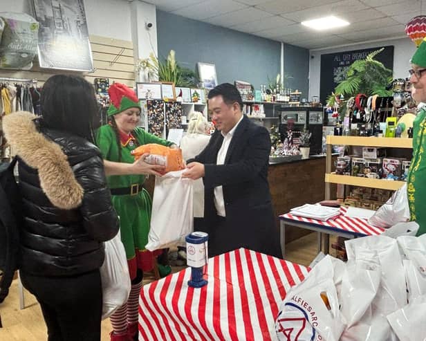 Alan Mak MP helps to give out Christmas food parcels and gifts at Alfie's Arc in Leigh Park, helped by Leanne and Carl Hutchins