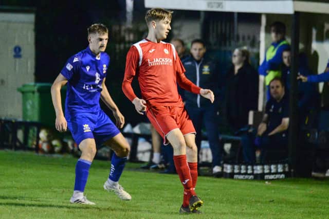Brandon Miller, left, keeps a close eye on Horndean's Harry Jackson. Miller was later taken to hospital with a head injury but was released at 5am this morning following a CT scan. Picture: Martyn White