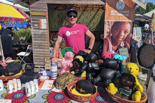 Stefan Swaffer is manning the Arms Around the Child charity stalls, which is selling items and also offering glitter makeovers. Picture: Emily Jessica Turner.