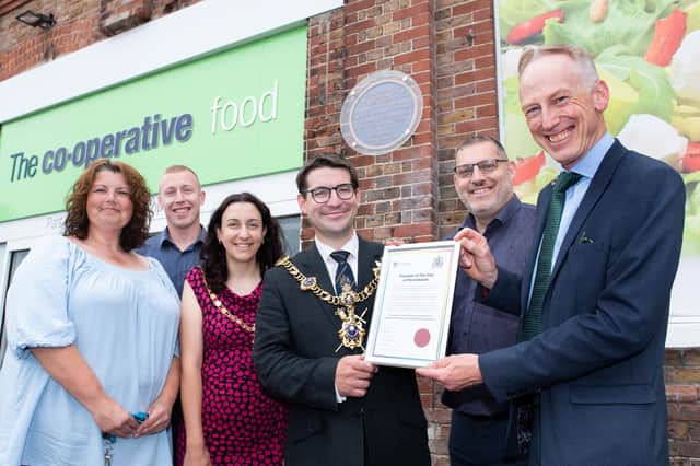 The Southern Co-op's freedom of the City of Portmouth is presented by Lord Mayor Cllr Tom Coles and Lady Mayoress Nikki Coles to CEO Tom Smith, right, and colleauges Tony Scott, second right, Ollie Levens, second left, and Holly Branble, left, at the Highlands Road store, Southsea. Picture: Steve Reid Blitz Photography