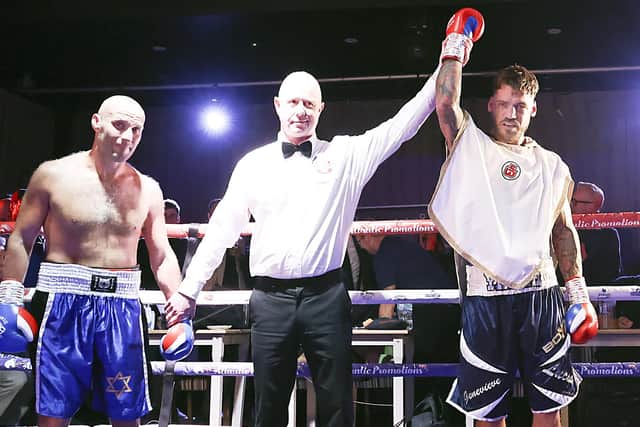 Joel McIntyre, right, has his hand raised after defeating Nikita Basin on his ring return last October. Picture: Barry Zee