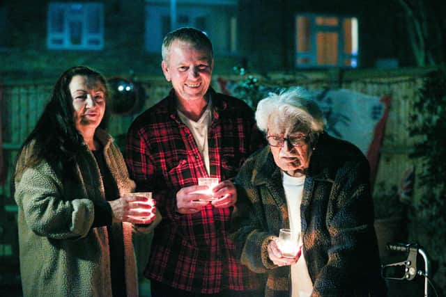 Joanna and David White and Joanna's father, John Castleton, use candles to make a Beacon of Remembrance in Grosvenor St, Southsea
Picture: Chris Moorhouse (230321-31)