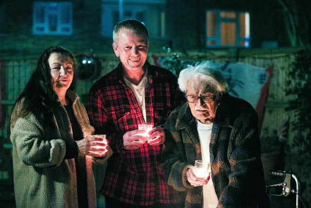Joanna and David White and Joanna's father, John Castleton, use candles to make a Beacon of Remembrance in Grosvenor St, Southsea 
Picture: Chris Moorhouse      (230321-31)