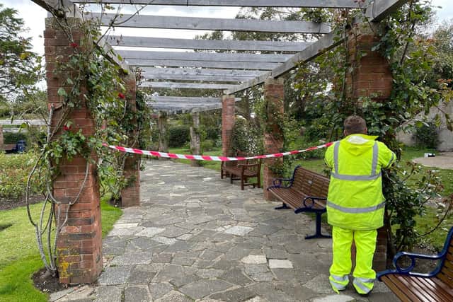 Council workers in the Rose Gardens on Sunday, May 23 after glass bottles were smashed on the ground. Picture: David Hyde