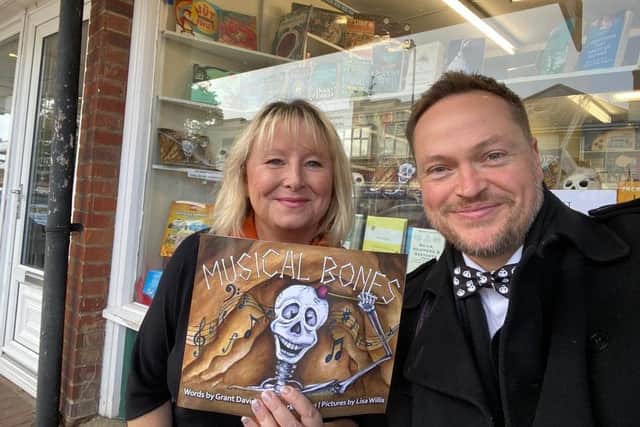 Lisa Willis and Mark Coates with a copy of Musical Bones