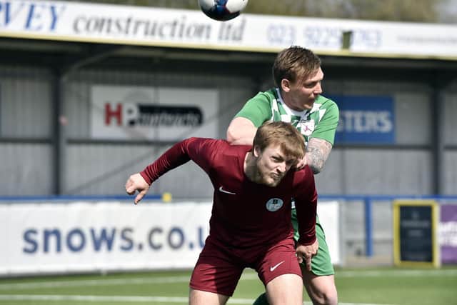 Mob Albion's Jon Byerley wins this header against Burrfields. Pic: Allan Hutchings