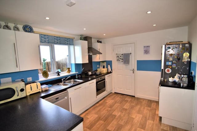 The modern kitchen is fitted with a range of appliances and has spectacular sea views.