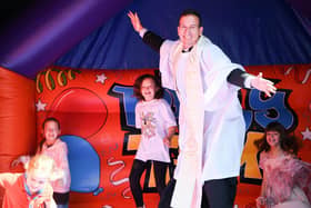 The Rev Luiz Lima on a bouncy castle