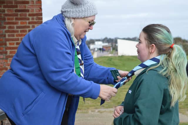 Sue Archer, group Scout leader, investing Sophie Smith, known to the Cubs as Kaa, as an adult leader