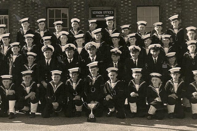 The boys of the HMS Vernon cadet corp with their trophy for winning the gun run in 1952.