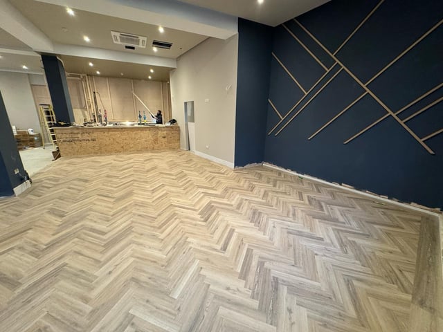 The bar area can be seen at the back of the room.