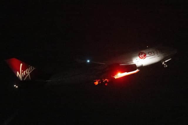 Cosmic Girl, a Boeing 747-400 aircraft, carries the LauncherOne rocket under its left wing. Picture: Matthew Horwood/Getty Images