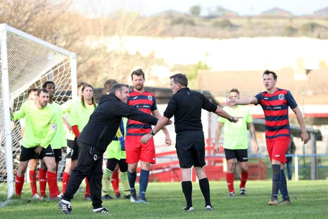 Bush Hill manager Eugene McManus talks to referee Craig Sandoe after he awarded Paulsgrove an indirect free-kick on the edge of the Bush six-yard box. Picture: Chris Moorhouse