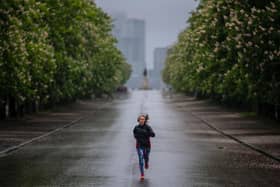 Joggers take their daily exercise in the rain at Greenwich Park in London (Photo: Justin Setterfield/Getty Images)
