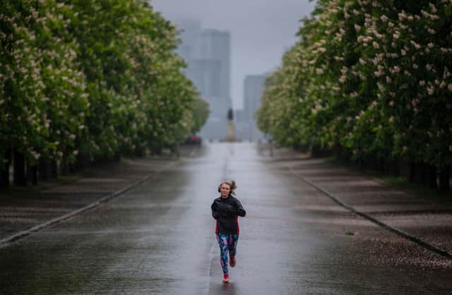 Joggers take their daily exercise in the rain at Greenwich Park in London (Photo: Justin Setterfield/Getty Images)