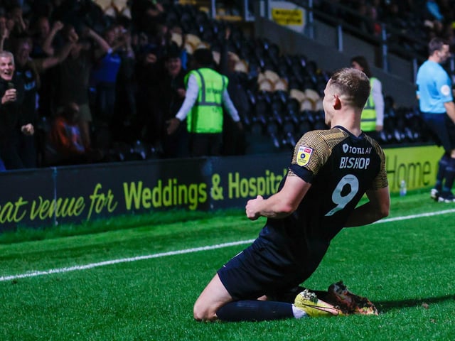 Colby Bishop celebrates in front of the 1,000 Pompey fans who made this season's trip to Burton.