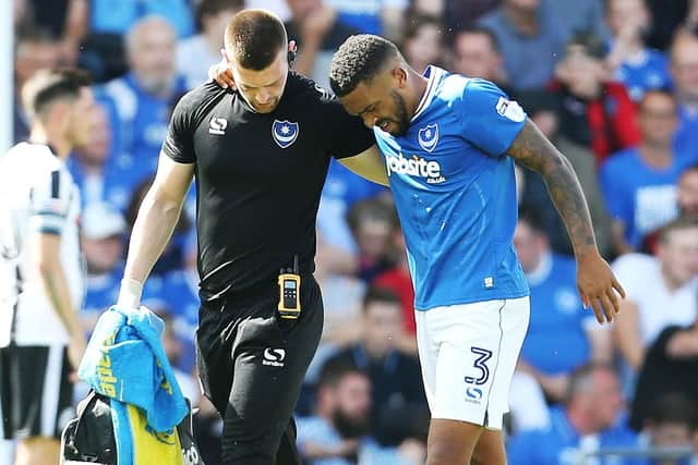 Tareiq Holmes-Dennis limps off on his Pompey debut - an injury that's caused him to retire. Picture: Joe Pepler