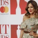 British television presenter Caroline Flack poses on the red carpet on arrival for the BRIT Awards 2018 in London on February 21, 2018.