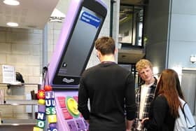 Portsmouth students looking at the giant phone in the University Library