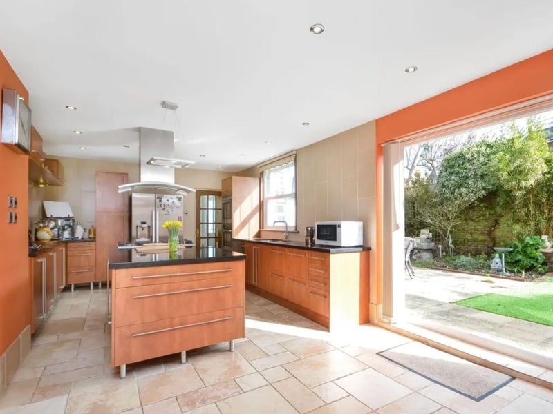 The listing says: "This individual detached home stands out amongst the stuccoed neighbouring homes. The accommodation provides 3702 sq ft of living space including the store and garaging."