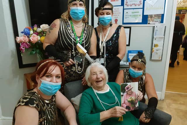 Celebrating 100 years Roaring Twenties style, Maragaret Fry is pictured with care home staff. Picture: Contributed.