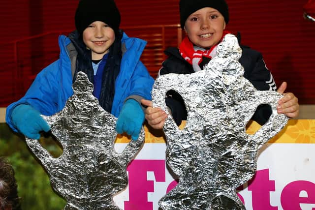 Magic of the (tinfoil) FA Cup - Salford City fans with their home-made trophies. Photo by Alex Livesey/Getty Images.