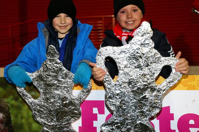 Magic of the (tinfoil) FA Cup - Salford City fans with their home-made trophies. Photo by Alex Livesey/Getty Images.