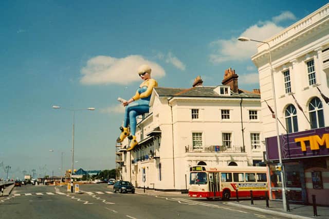 A giant balloon in the shape of a woman sitting on the roof above Bar Bluu in South Parade, Southsea, 1999. Picture: Doreen Gallacher.