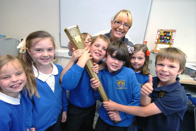 Olympic flame bearer Tina English dropped into Dore Primary School to give pupils a close up look at the torch she carried. Our picture shows Tina, pupils and the torch.