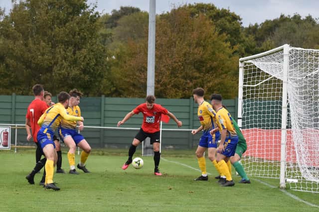 Fareham striker Josh Benfield, middle, about to score in last weekend's 3-3 Vase draw with Badhsot Lea, with the Reds progressing on penalties. Pic: Paul Proctor.