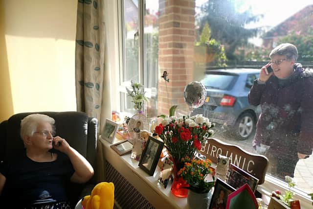Jackie Dunford (right) talking to her mum Rosemary Clarke at her care home Elizabeth Lodge, Beech Grove, Alverstoke, Gosport. Rosemary has dementia and Jackie regularly visits but the care home is now in shut down so she went to visit and the care home handed my nan the phone so they could chat without putting anyone in danger!
