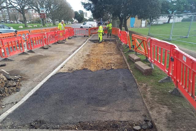 Workers creating a new drop kerb in front of Castle Field in Southsea for sea defence works. Picture: Southsea Coastal Scheme