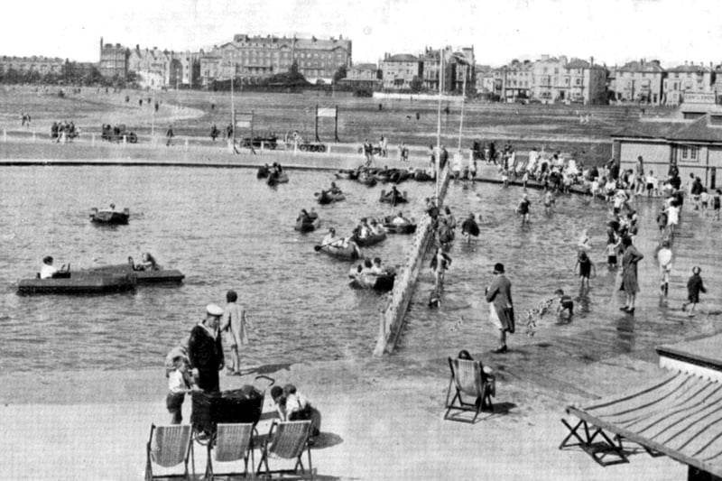 The children's boating and bathing pool, near Southsea Castle. It was constructed so that even the tiniest children could paddle. To the forefront can be seen a sailor in square rig, home on leave perhaps with the family. In the distance the Queens Hotel overlooks Southsea common. The site is now Blue Reef Aquarium.