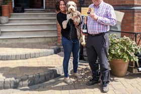 100th customer Peter Clarke celebrates with a bottle of bubbly