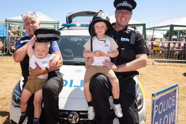 Alfie, aged two, and Frankie Akhurst, aged three, with PCSO Ann Adams and PC Steve Cann.