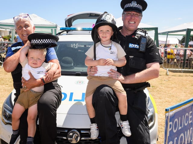 Alfie, aged two, and Frankie Akhurst, aged three, with PCSO Ann Adams and PC Steve Cann.