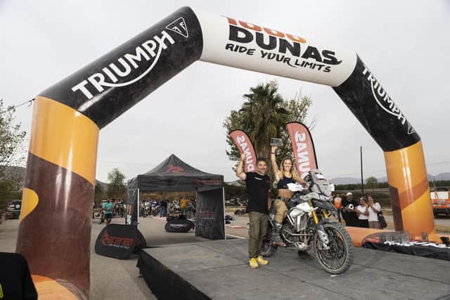 Portsmouth graduate Vanessa Ruck became the first British female motorbike rider to complete the 1000 Dunas Raid rally on a large adventure bike. Pictured is her at the desert rally finish line with Aled Price.