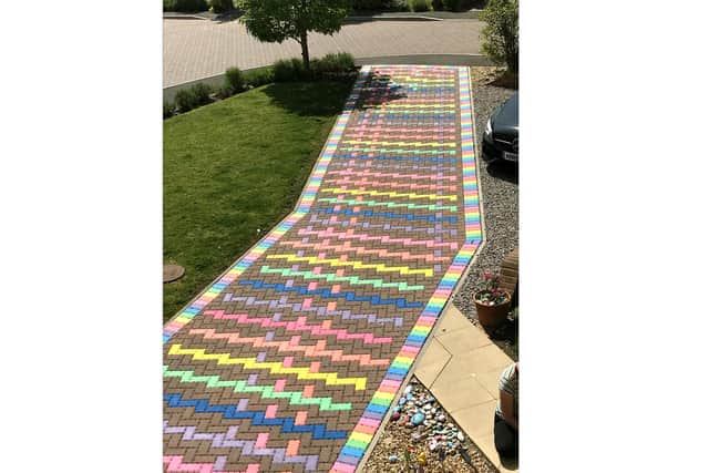 Lily Bond, 16 from Fareham, has been creating a rainbow tribute to the NHS on her driveway. The teenager has autism and recently spent time in hospital with a seizure disorder. Pictured: the colourful artwork
