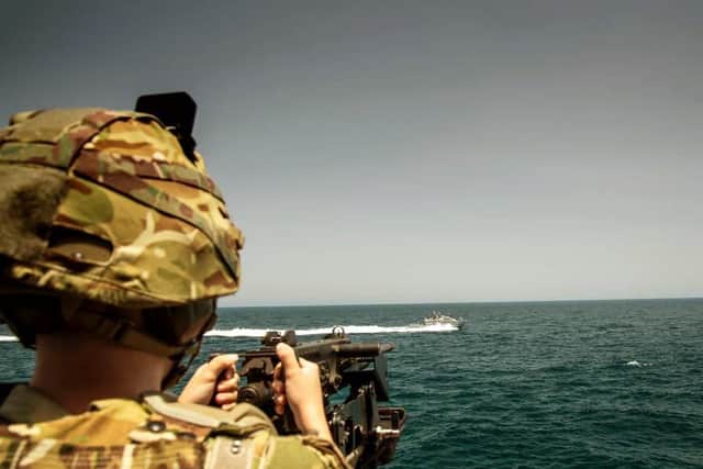A gunner on HMS Argyll trains his weapon on fast-attack craft in the Gulf