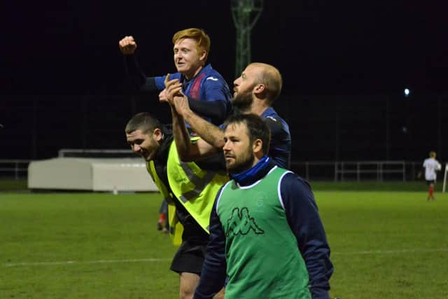 Goalscorer Frankie Paige hitches a lift off the pitch from Harry Bedford after USP's FA Vase win against Millbrook. Pic: Daniel Haswell.