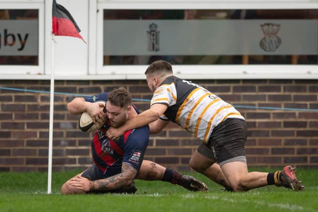 Ryan Merrikin forces his way over for US Portsmouth. Picture: Keith Woodland