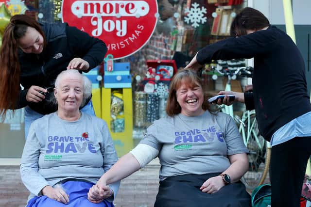 Anne Stigar, left, and Jeanette Thomas. Jeanette Thomas and family and friends have their heads shaved for Macmillan in Gosport High StreetPicture: Chris Moorhouse (jpns 121122-55)