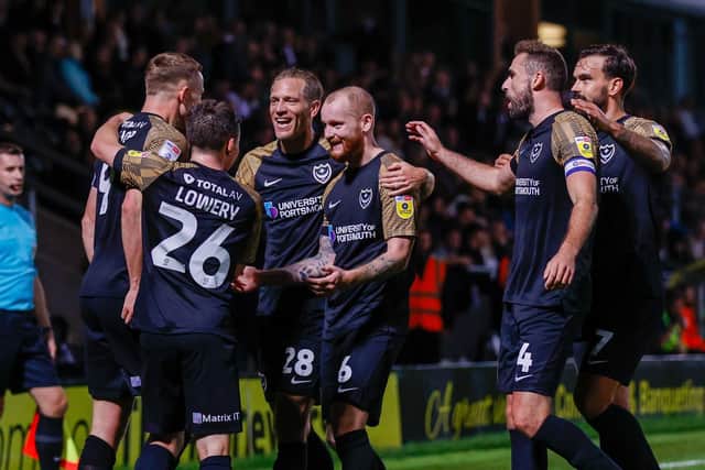 The Pompey players rush to congratulate Colby Bishop for his goal in the 2-0 midweek win against Burton     Picture: Simon Davies