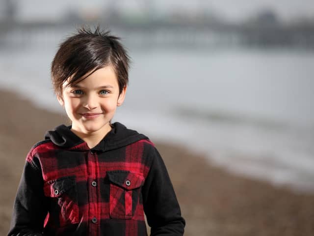 Thomas Roughan, 8, reads his poem called Ruby Red about racism which has been featured on the Black Lives Matter website. Pictured on Southsea beach.
Picture: Chris Moorhouse   (081120-22)